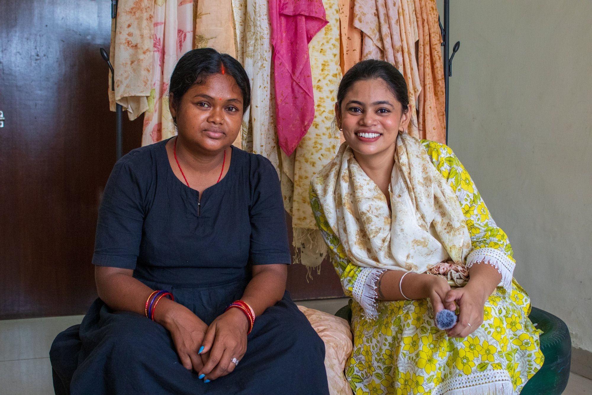 The makers of Ecoshi in front of naturally dyed scarves