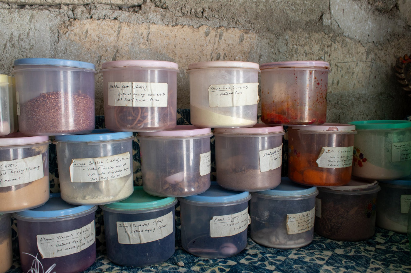Jars of natural dye ingredients such as madder root and alum
